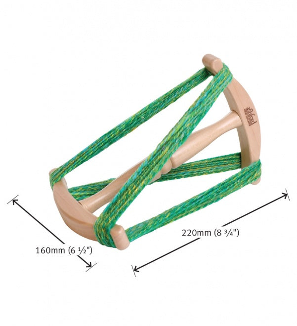 sampler niddy noddy holding a green and yellow skein of yarn