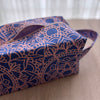 Blue and pink patterned bag on a wooden surface