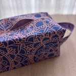 Blue and pink patterned bag on a wooden surface