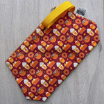 Fabric pouch with Halloween-themed pattern on a wooden surface