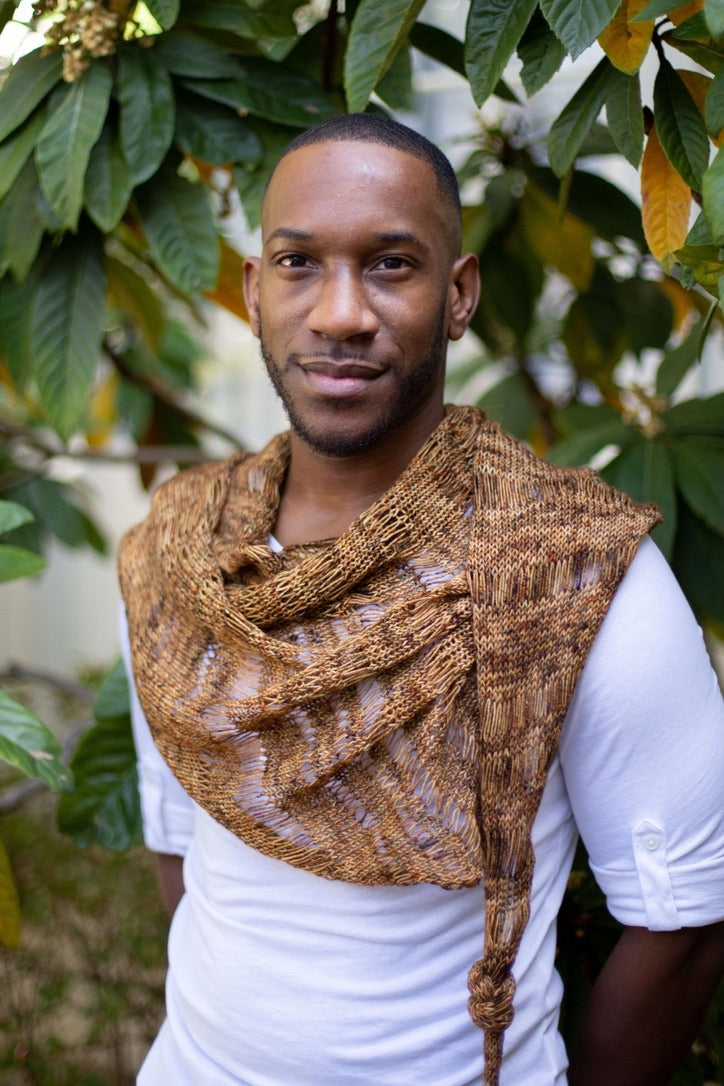a black man wearing a brown knit cowl