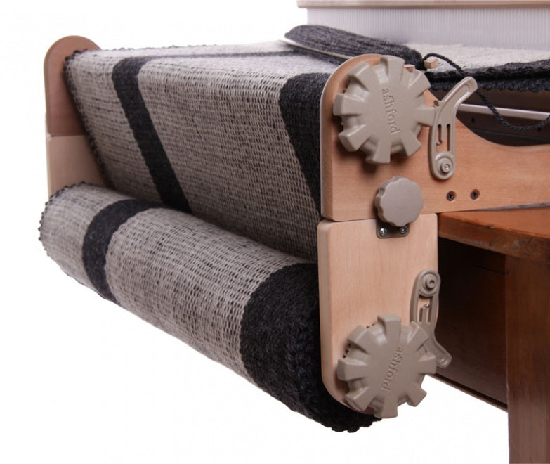 freedom roller attached to a rigid heddle loom holding woven fabric.